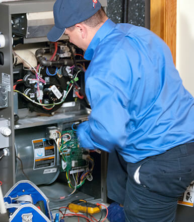 Technician repairing a gas furnace with multimeter, safety check and clean workspace in Ypsilanti. A‑Team Heating & Cooling. Call (734) 999-7310. Call (734) 999-7310 for Ypsilanti, MI.