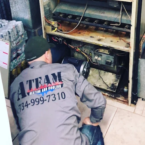 hvac technician repairing ac unit ann arbor mi a team heating cooling call 734-999-7310